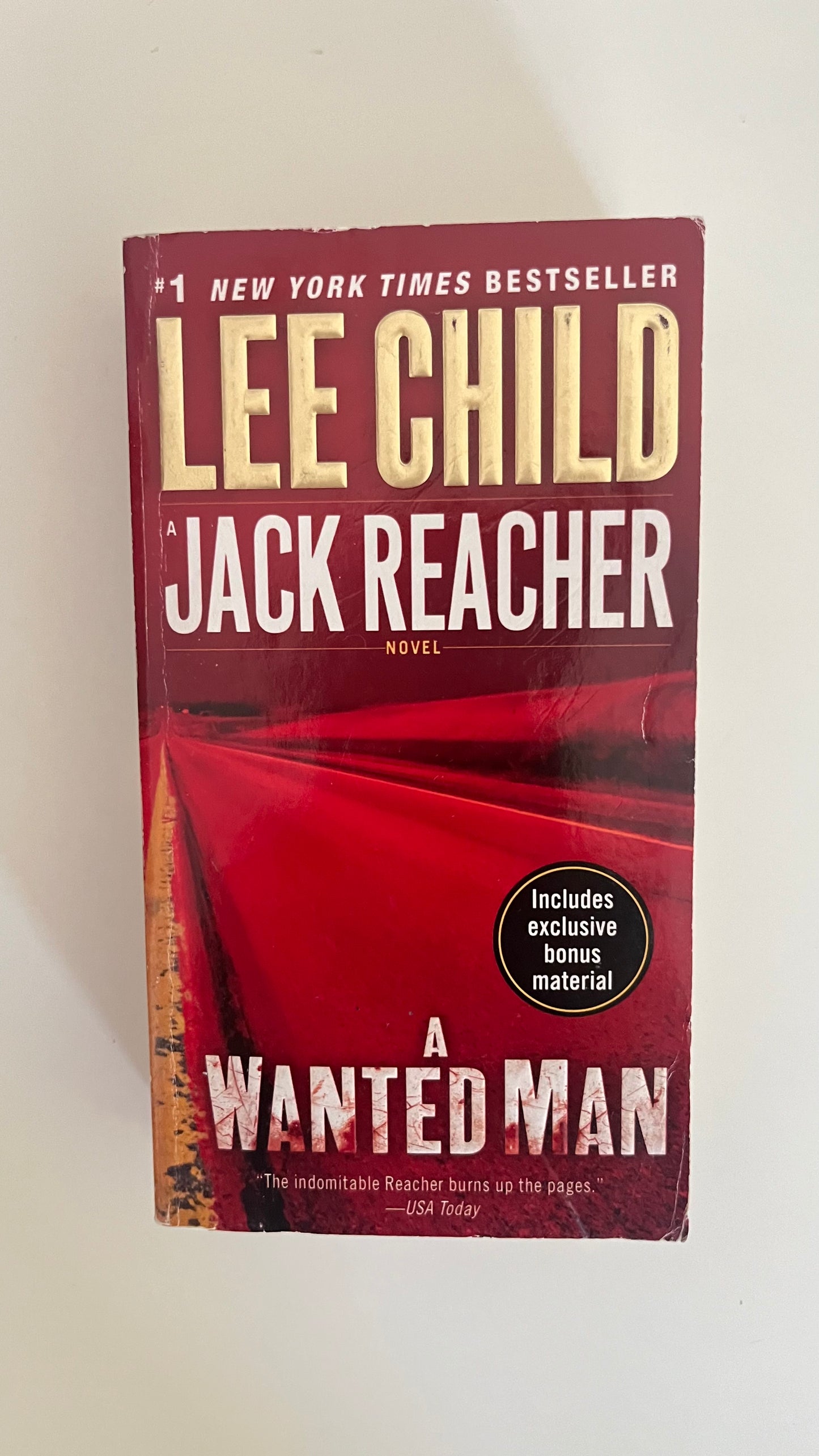 Paperback edition of A Wanted Man by Lee Child with a rugged, mysterious highway scene on the cover.