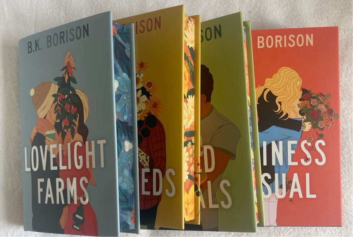 Five books by B.K. Borison arranged vertically on a white wall.