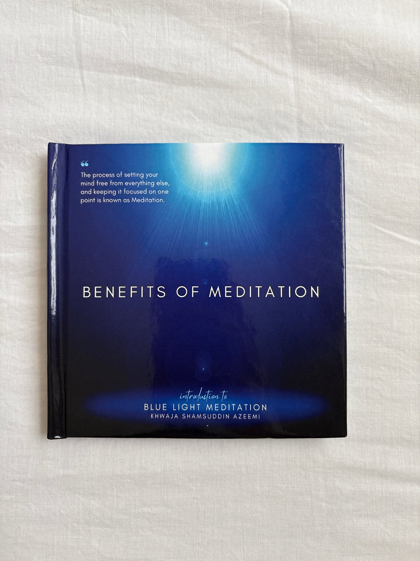 Blue packaging with 'Benefits of Meditation' text on a white fabric background