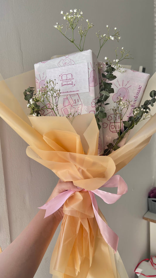 Aesthetic book bouquet wrapped in floral paper with handpicked preloved books from Preloved Books UAE.