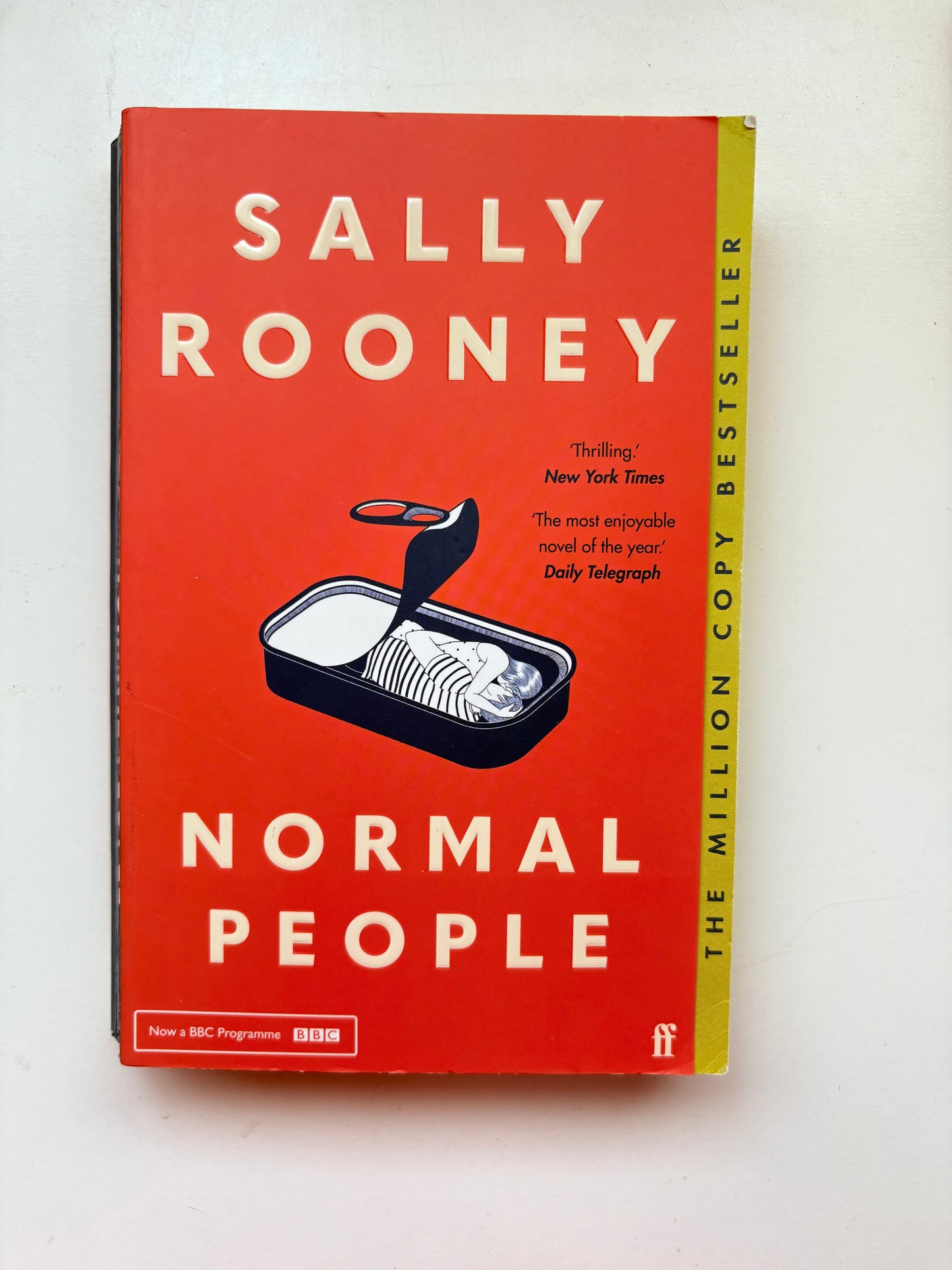 Book titled 'Normal People' by Sally Rooney on a white background