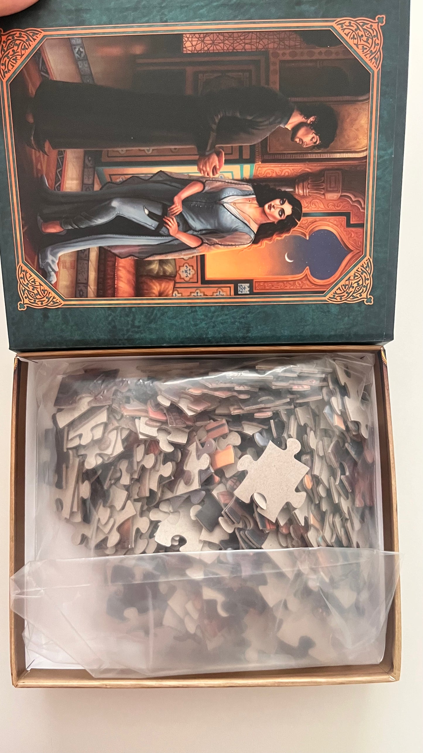 Jigsaw puzzle with a decorative box featuring an illustration of a man and woman.
