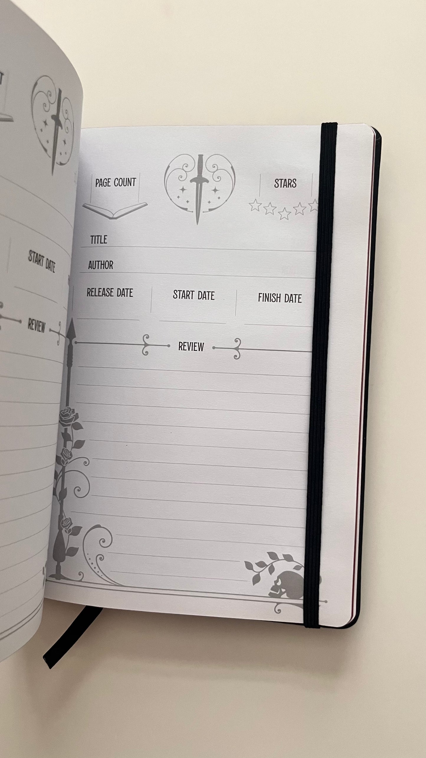 Open notebook with a page layout for tracking books, on a light beige background