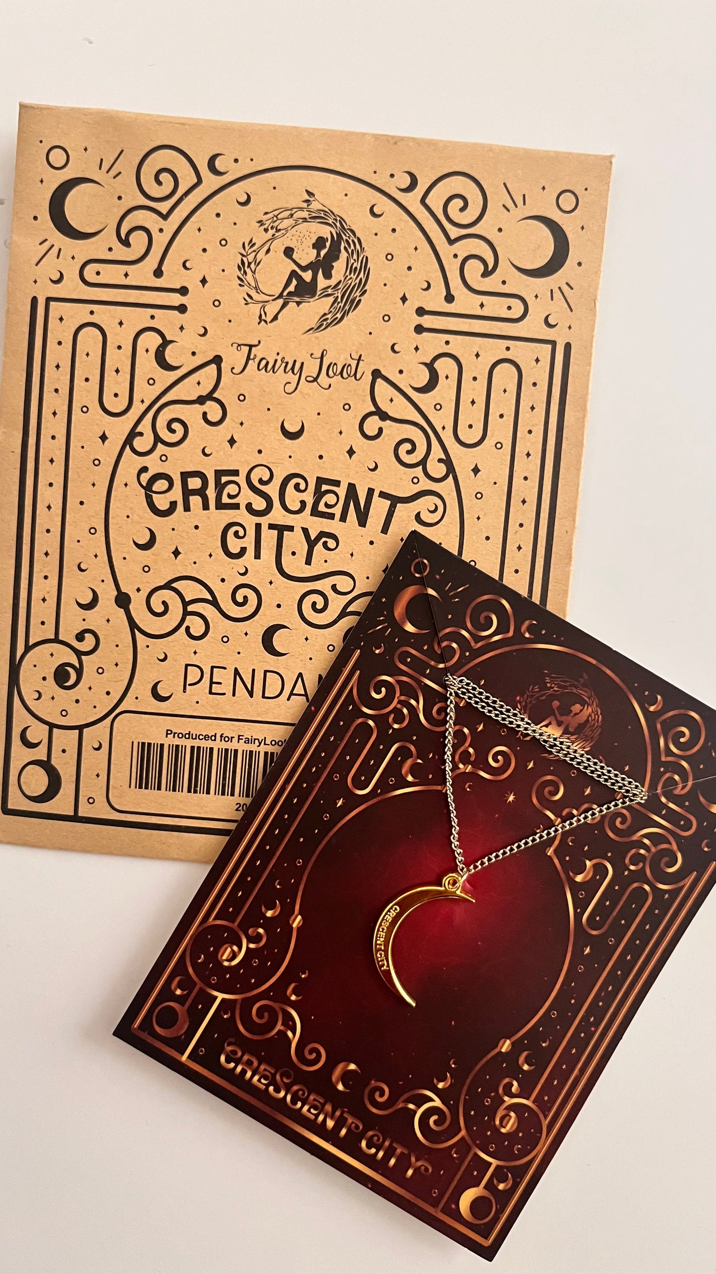 Crescent City pendant packaging with a necklace on a white background
