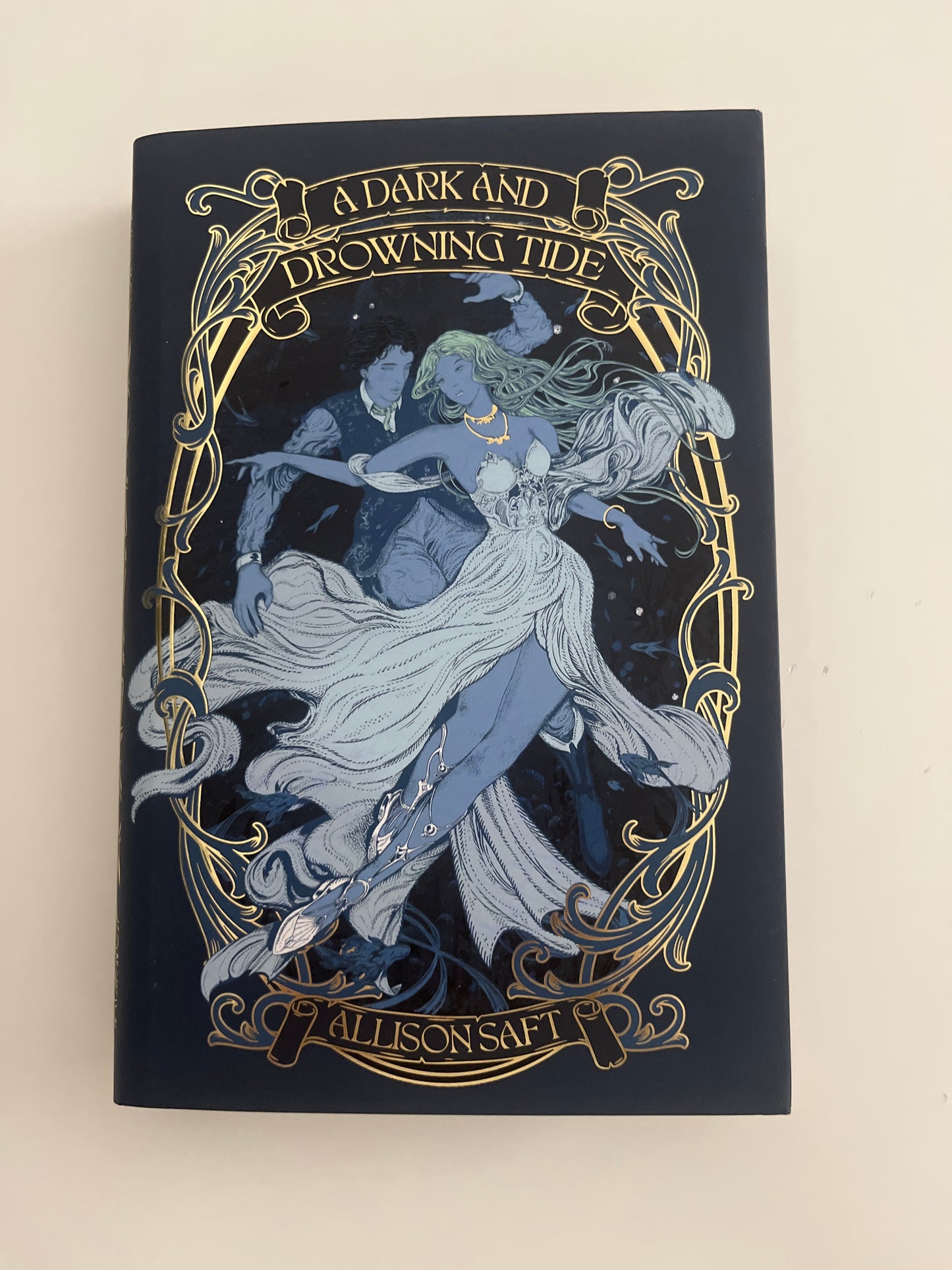 Decorative book cover with artistic design and text on a beige background