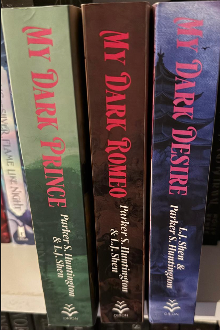 Three book spines titled 'My Dark Prince', 'My Dark Romeo', and 'My Dark Desire' by L.J. Shen and Parker S. Huntington.