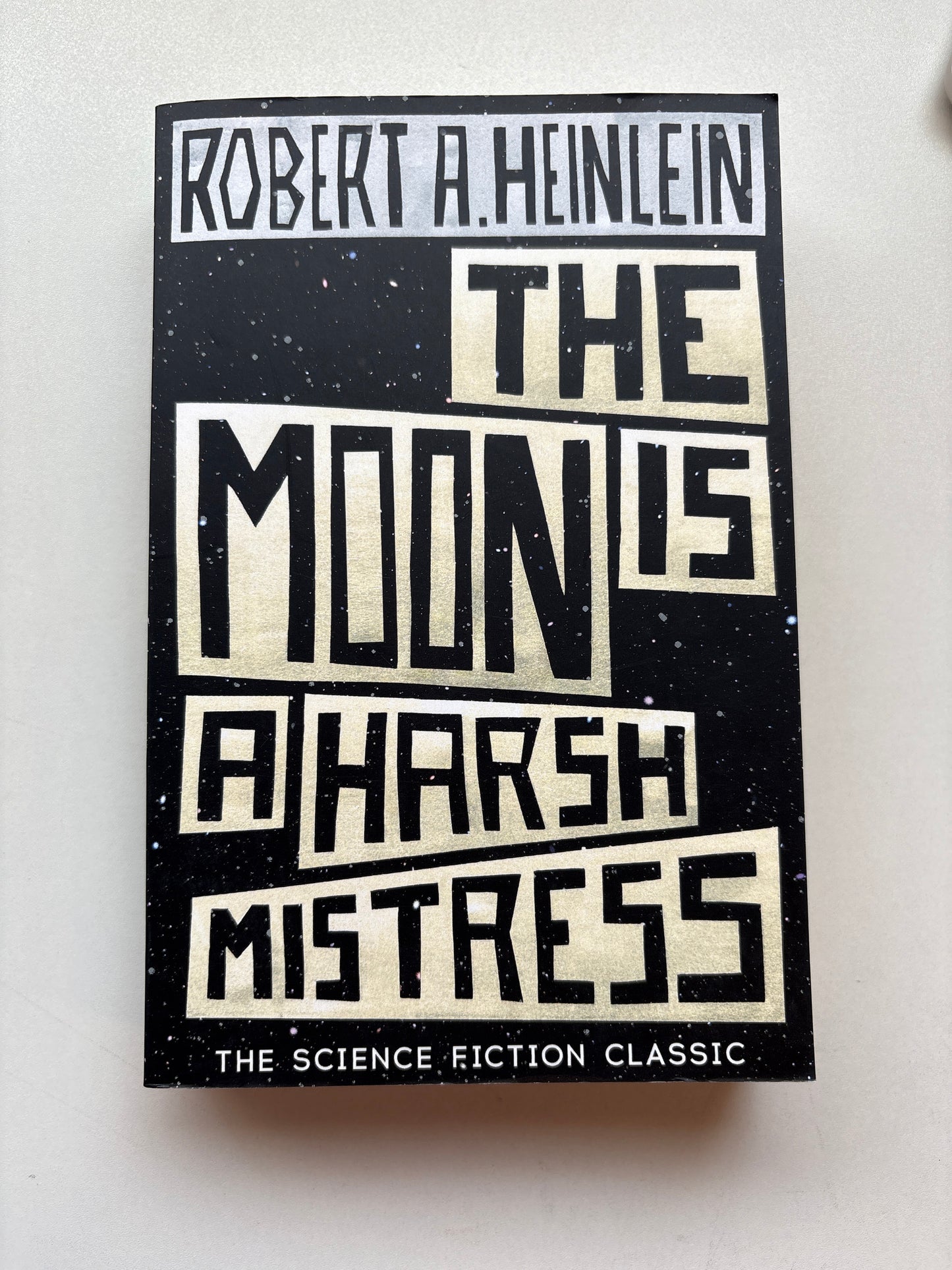 Book cover of 'The Mine's Harsh Mistress' by Robert A. Heinlein on a white background