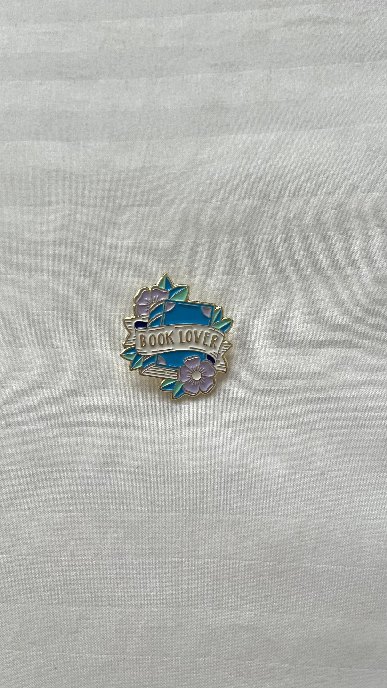 Colorful bookish enamel pins featuring quotes and literary icons
