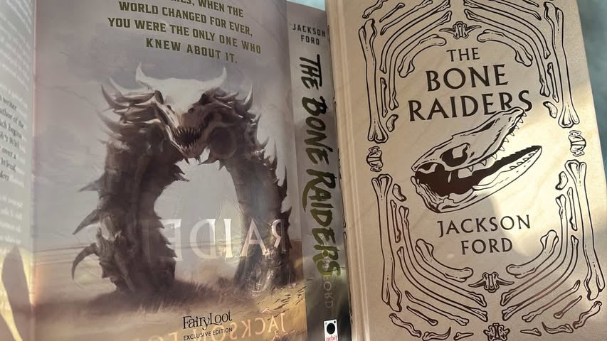 Book titled 'The Bone Raiders' by Jackson Ford with a dragon illustration on the cover.