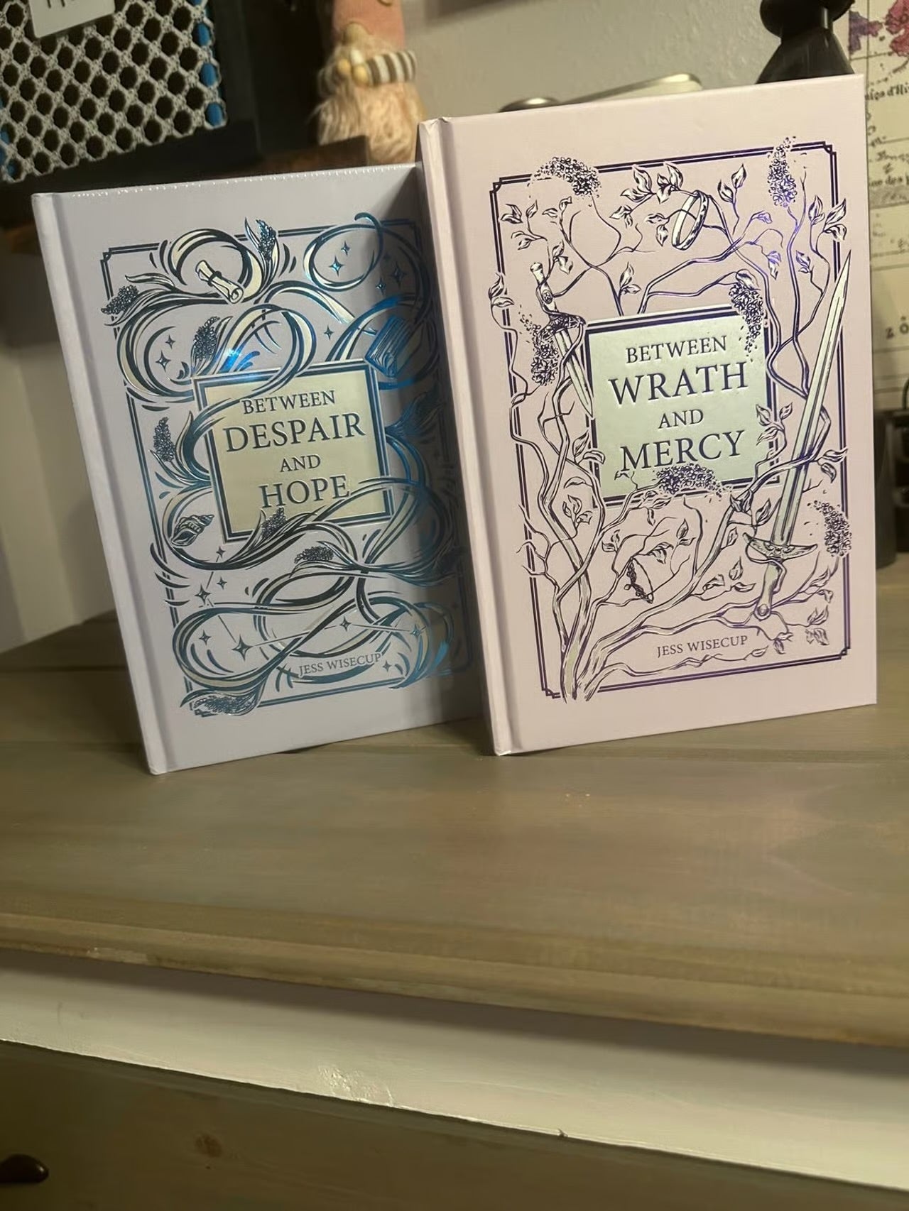 Bookish book: Between wrath and mercy by Jess Wisecup (Hardcover)