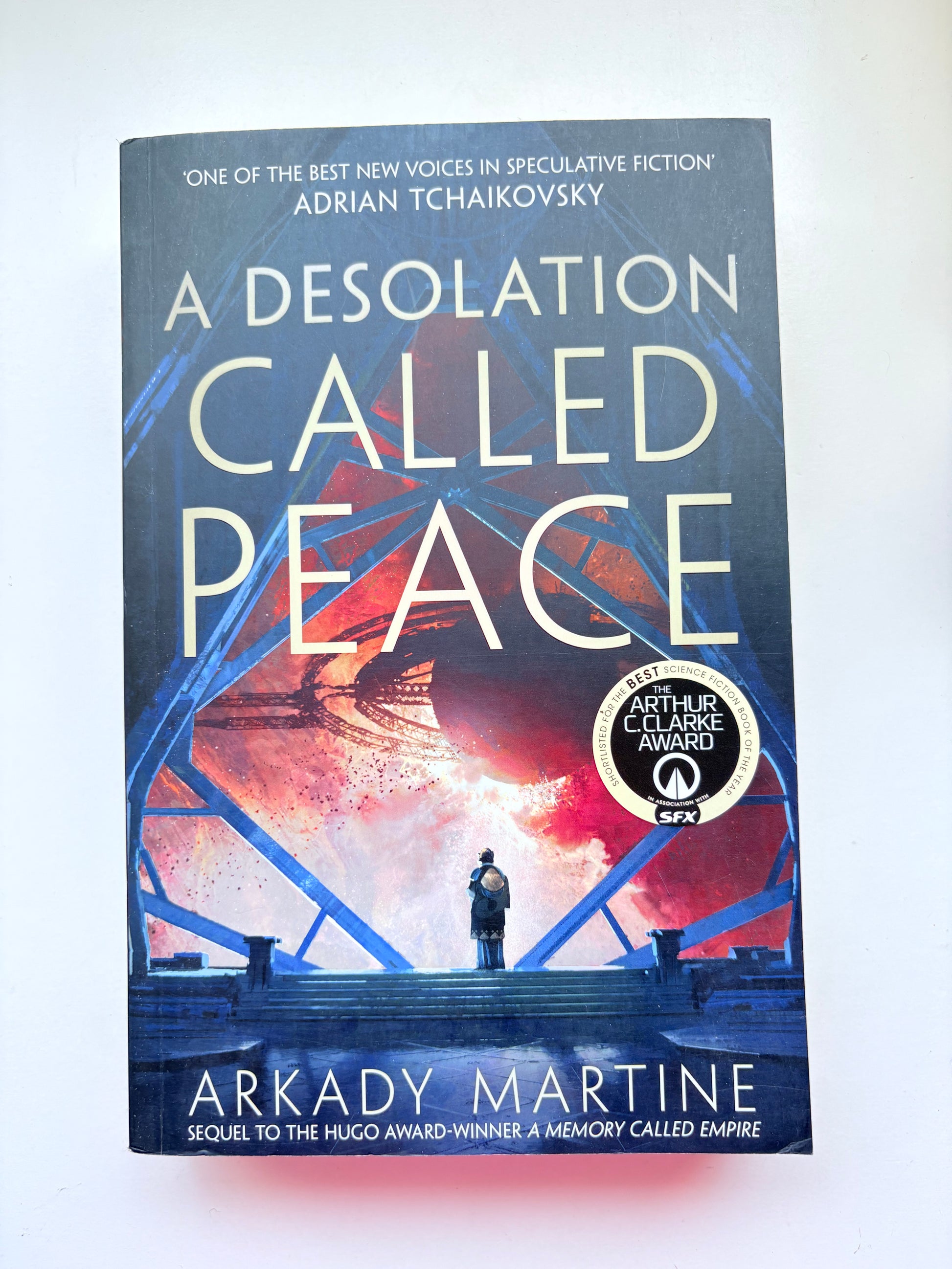 Book titled 'A Desolation Called Peace' by Arkady Martine on a white background