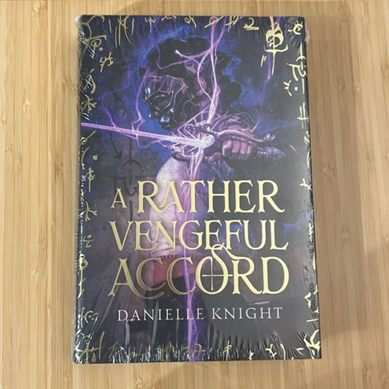 Book titled 'A Rather Vengeful Accord' by Danielle Knight on a wooden surface