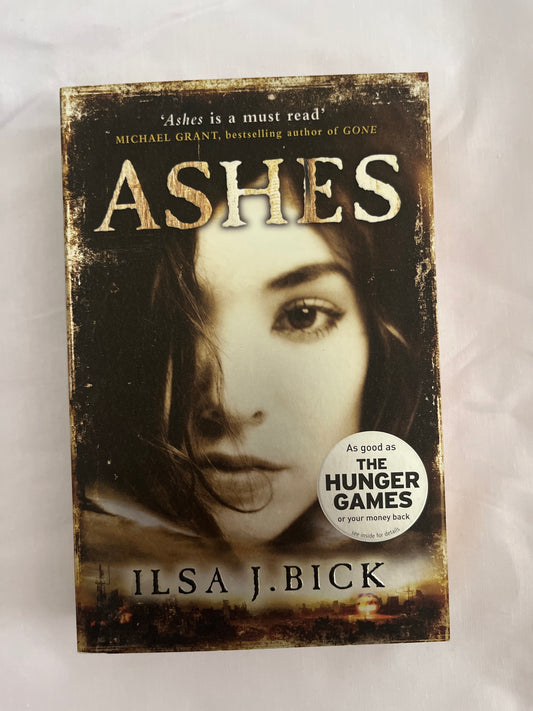 Ashes book cover with fire and destruction visual theme