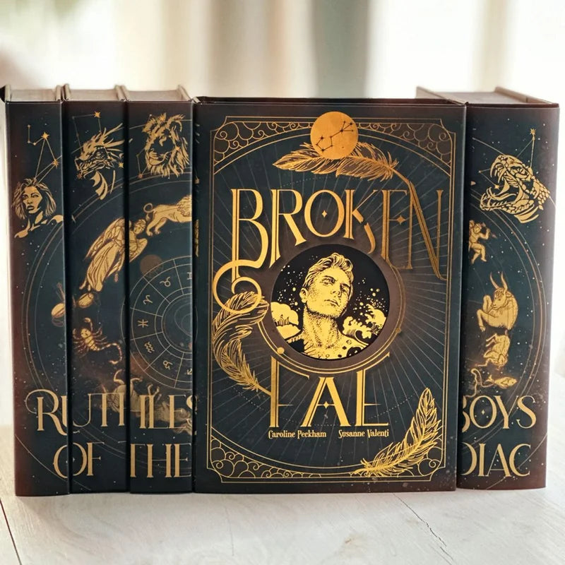 Decorative books with gold lettering and star signs on a white surface