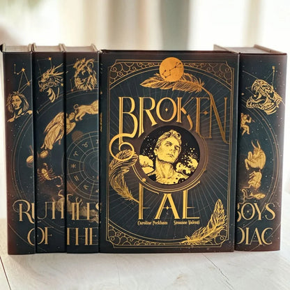 Decorative books with gold lettering and star signs on a white surface