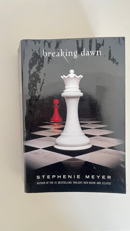 Paperback of Breaking Dawn by Stephenie Meyer with the signature chess piece cover design symbolizing power and choice.

