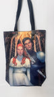 Tote bag with a design of two characters, one with red hair and the other in a dark outfit, on a white background.