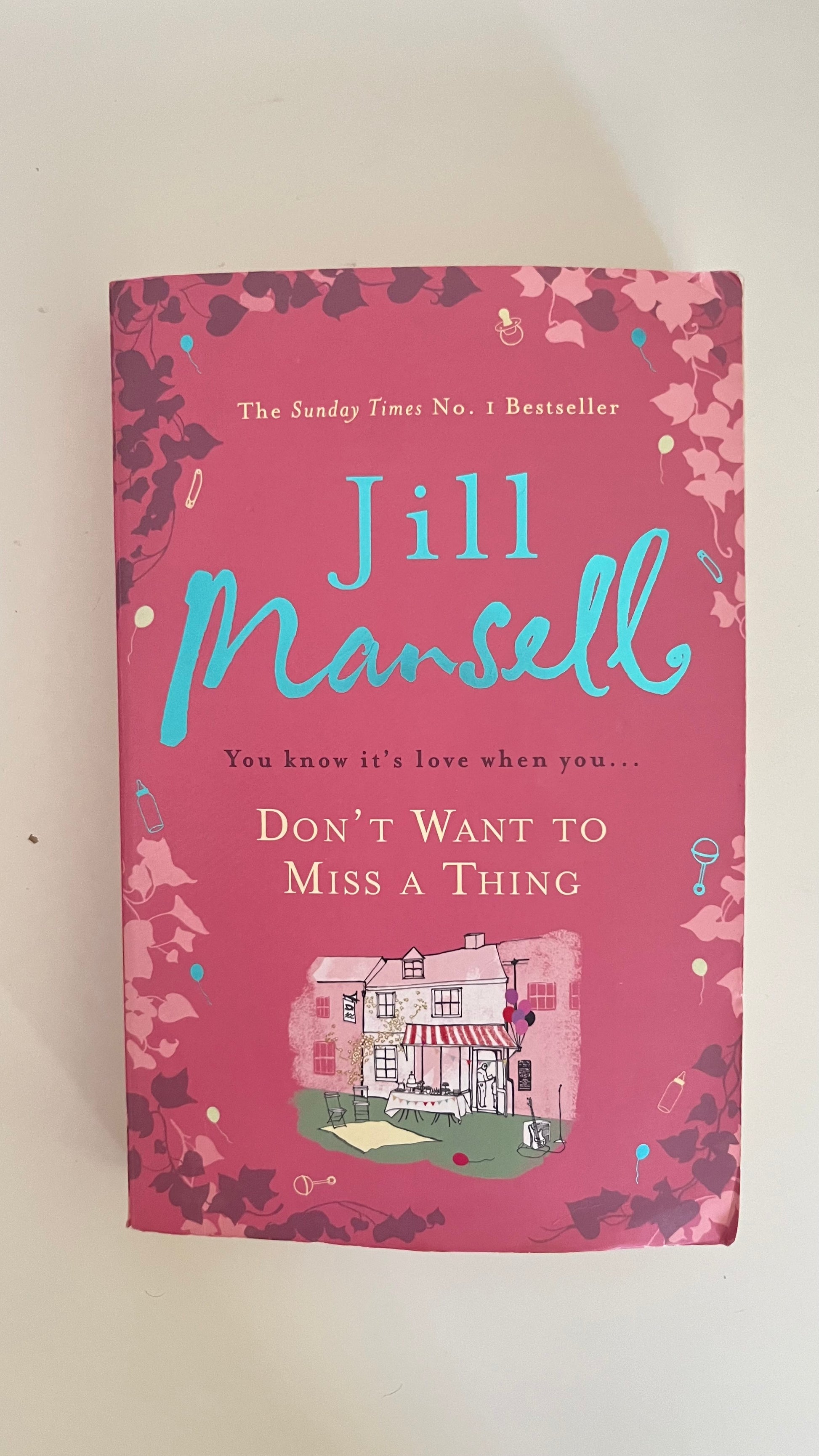 Paperback edition of Don’t Want to Miss a Thing by Jill Mansell with a bright, charming cover featuring countryside and romance motifs.

