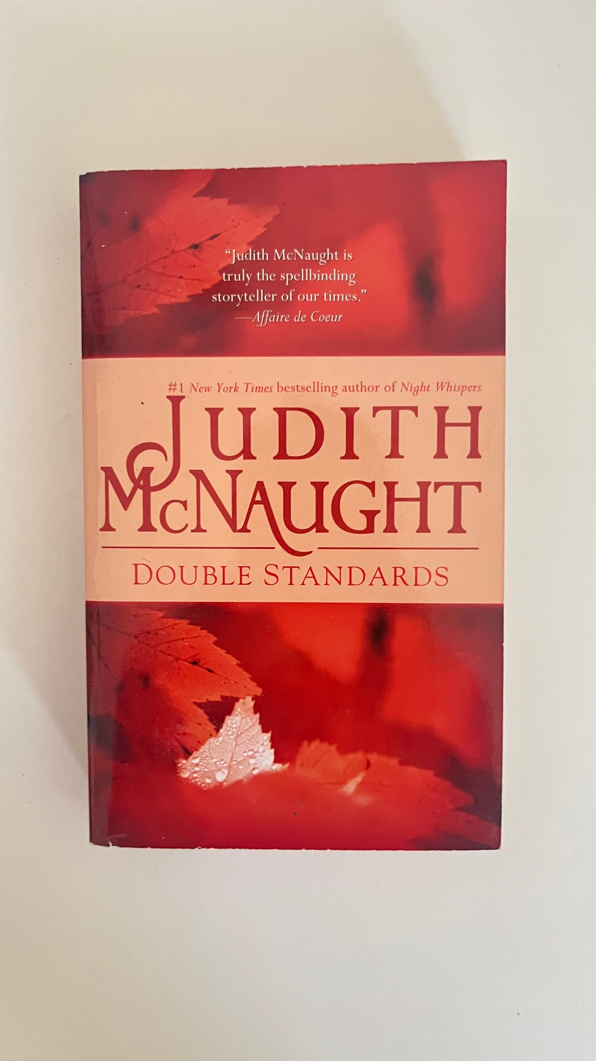 Paperback of Double Standards by Judith McNaught with a soft, dreamy romance-themed cover.


