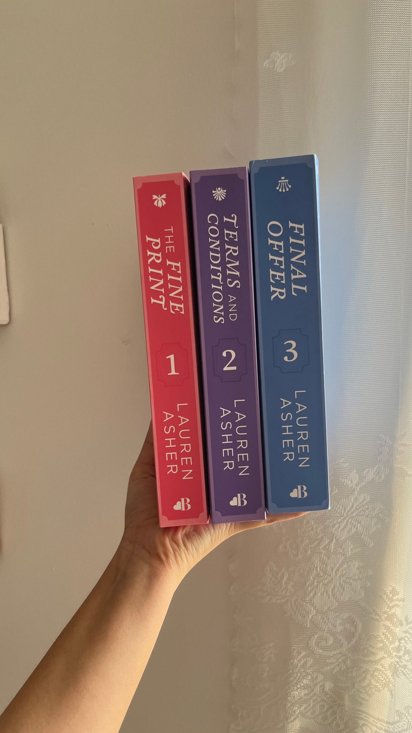 Box set of Dreamland Billionaires by Lauren Asher with vibrant and sleek modern cover designs.

