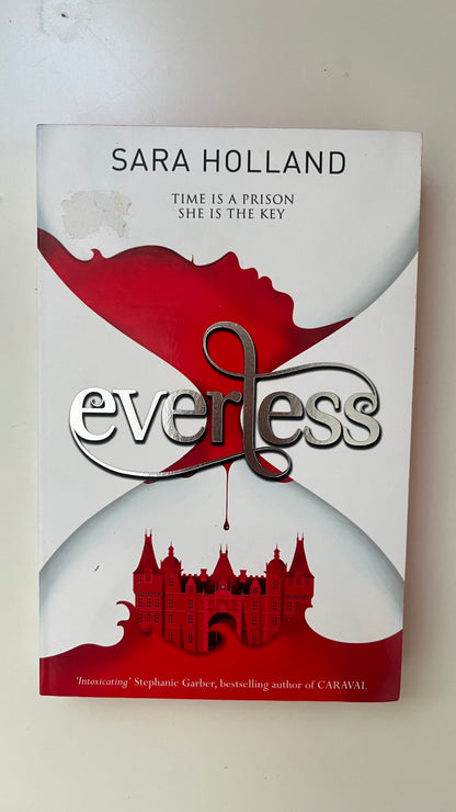 Paperback edition of Everless by Sara Holland with striking red sprayed edges and a dark fantasy-inspired cover.

