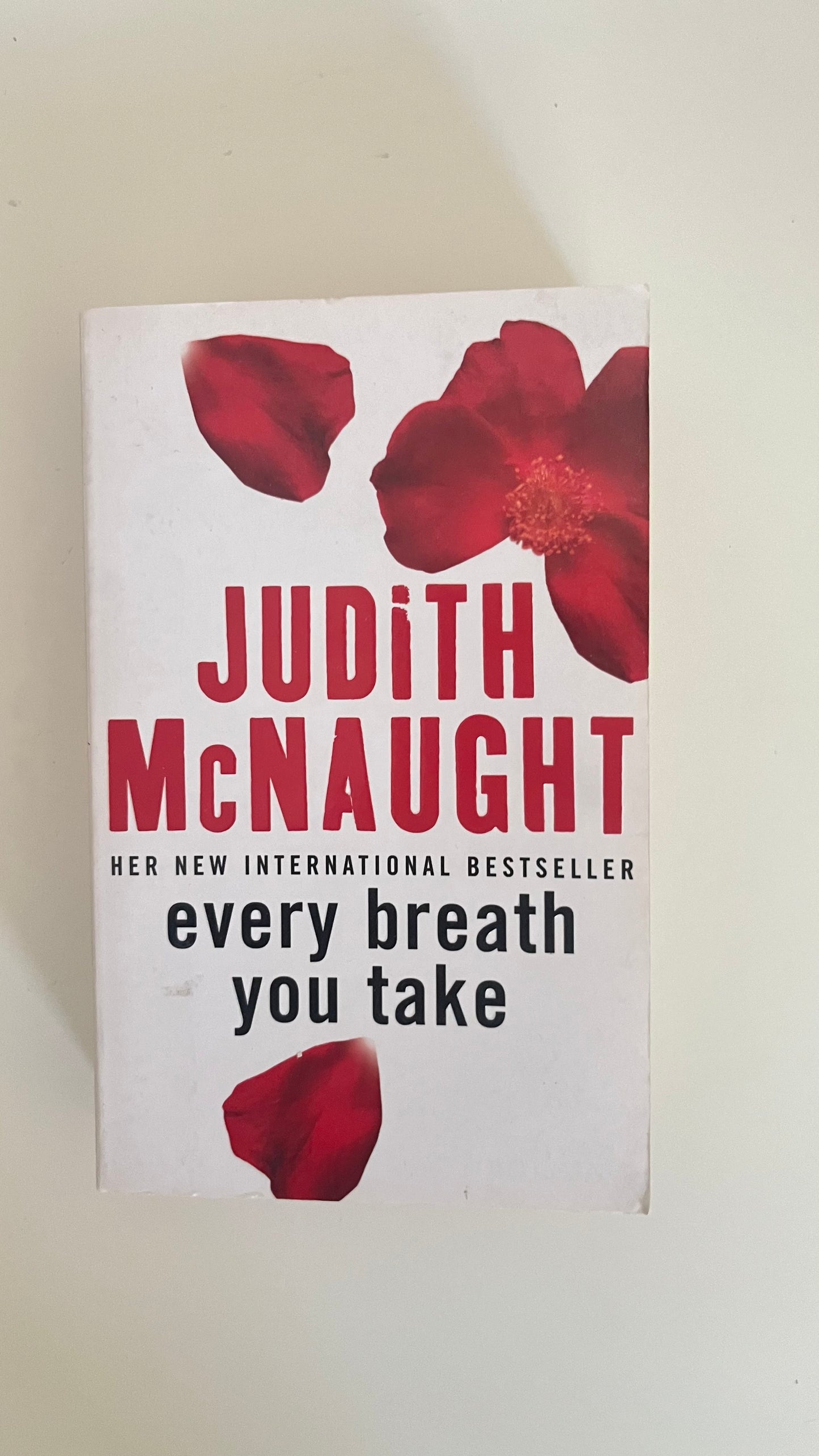 Paperback edition of Every Breath You Take by Judith McNaught with an elegant, mysterious skyline at dusk.

