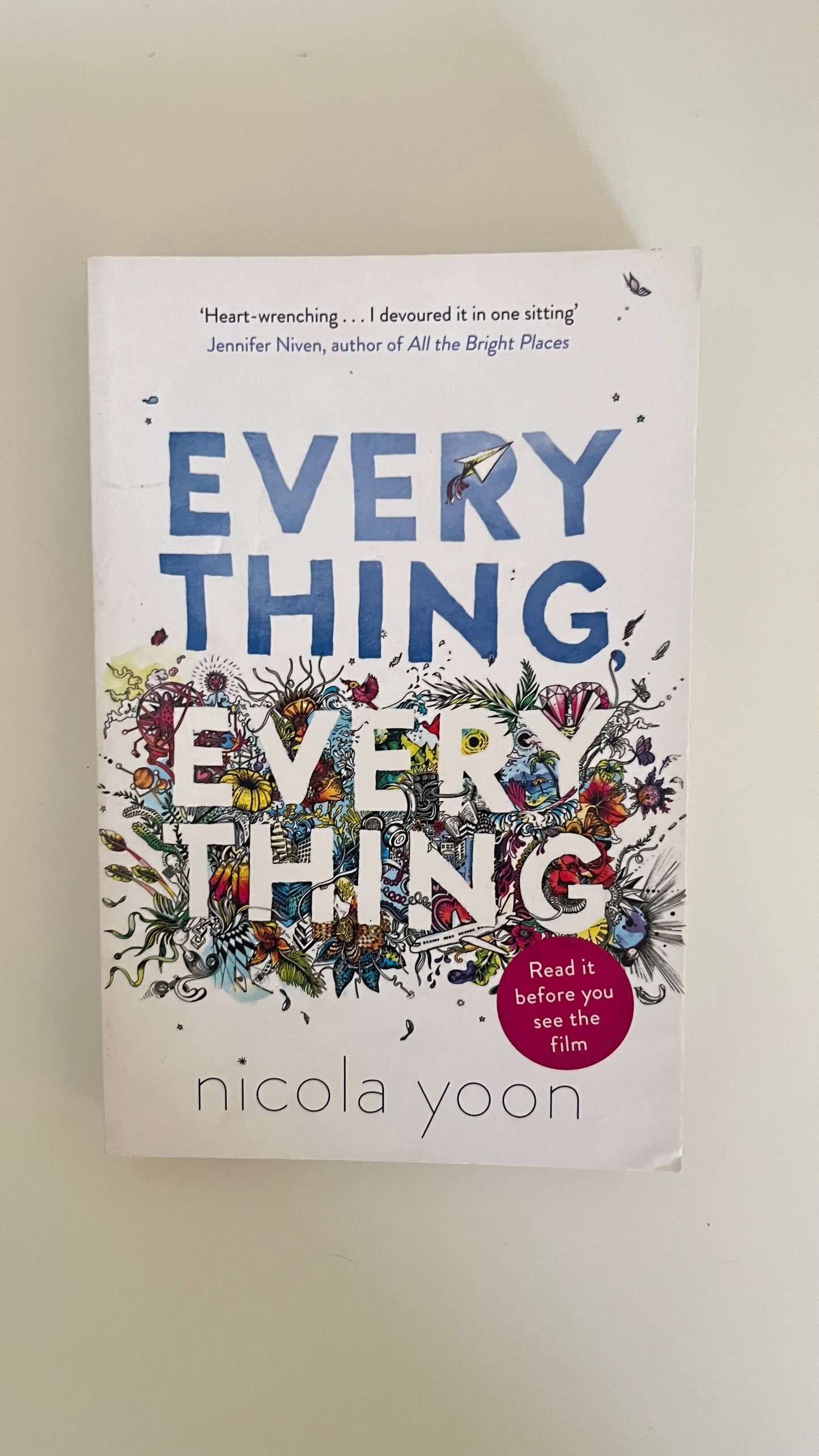 Paperback of Everything, Everything by Nicola Yoon with vibrant cover art reflecting the themes of love and illness.

