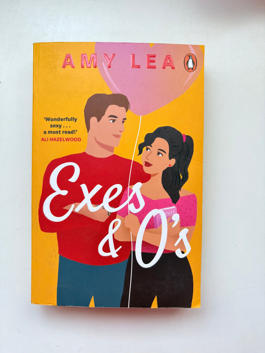 Book cover of 'Exes & O's' by Amy Lea with a couple holding a pink balloon on a yellow background.