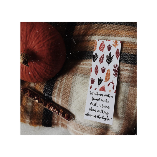 Bookmark with autumn leaf design and text on a plaid fabric background