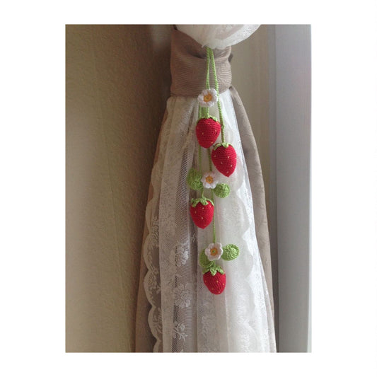 Crochet strawberry hanging ornament with green string