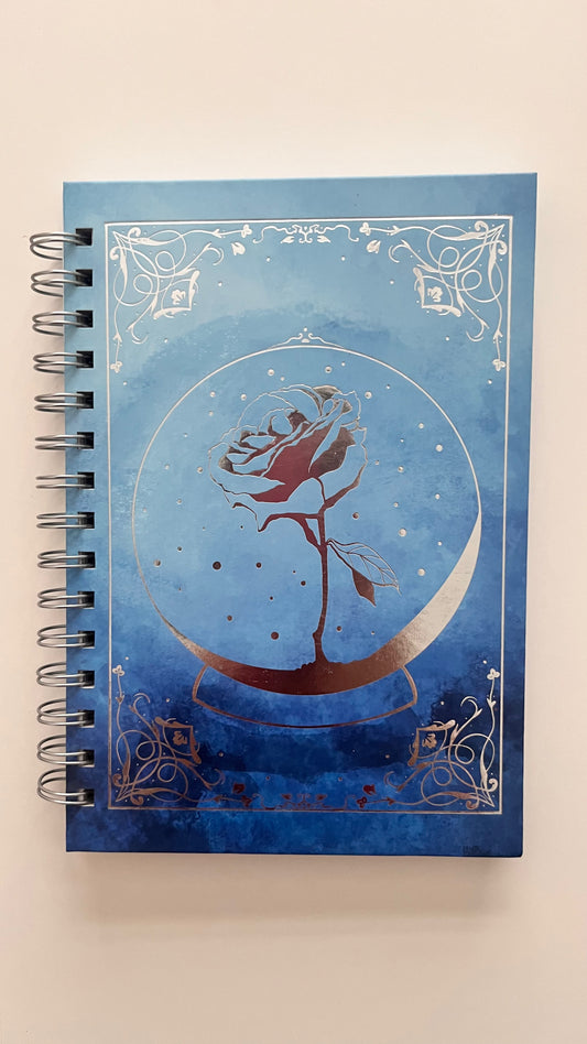 Notebook with a rose design on a blue background