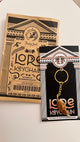 Lord keychain packaging with gold keychain on a white background