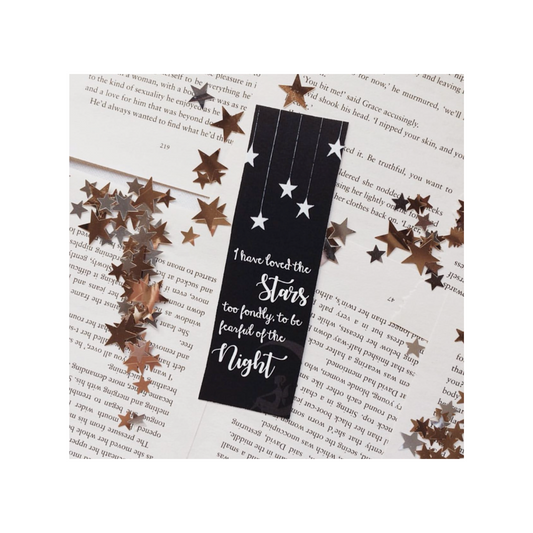 Black bookmark with star design on a book page
