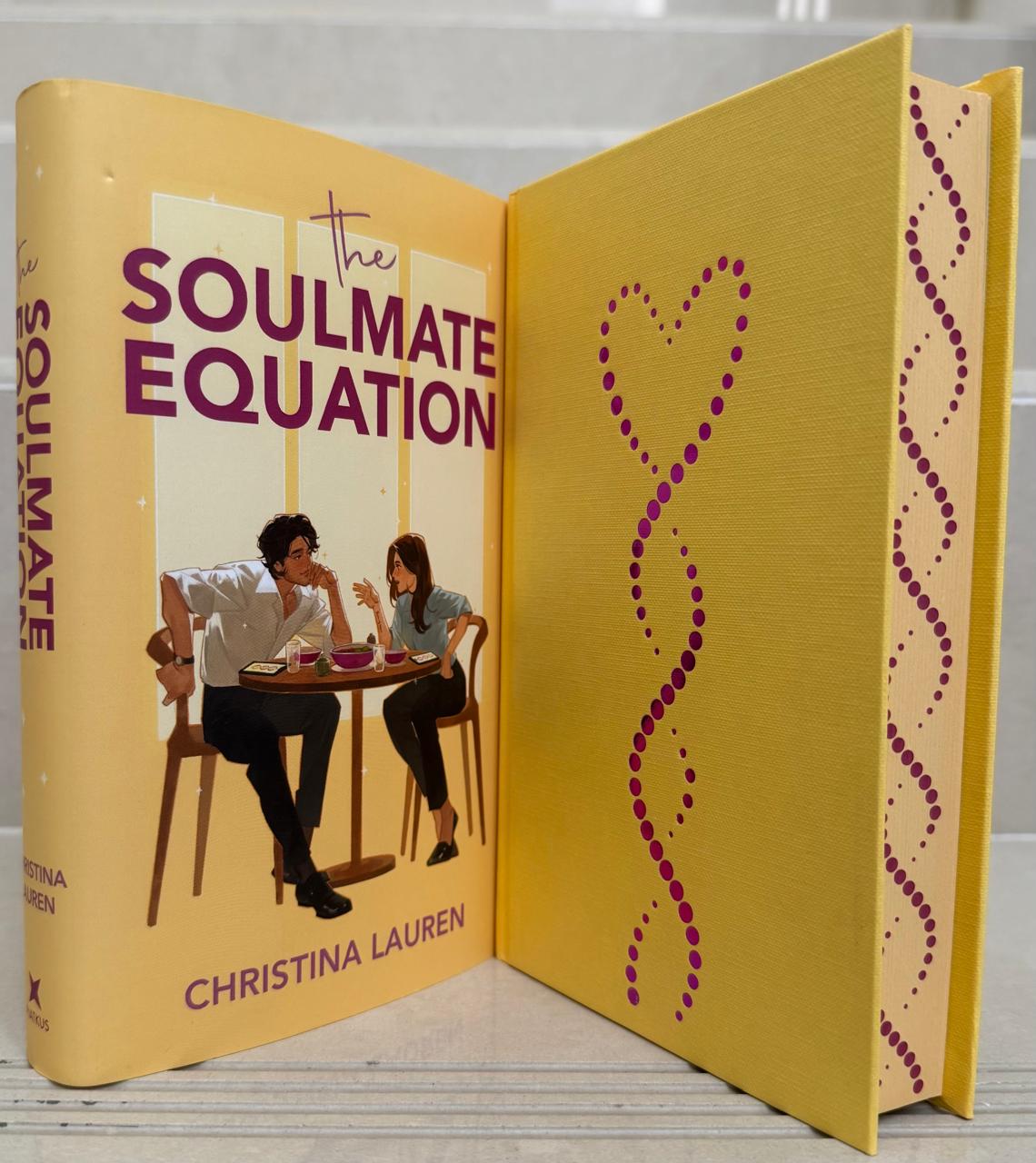 Book titled 'The Soulmate Equation' by Christina Lauren with a yellow cover and heart design.