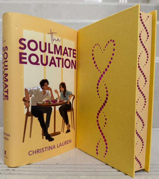 Book titled 'The Soulmate Equation' by Christina Lauren with a yellow cover and heart design.