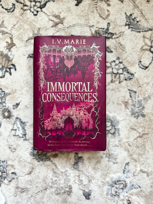 Book titled 'Immortal Consequences' by I.V. Marie on a textured surface