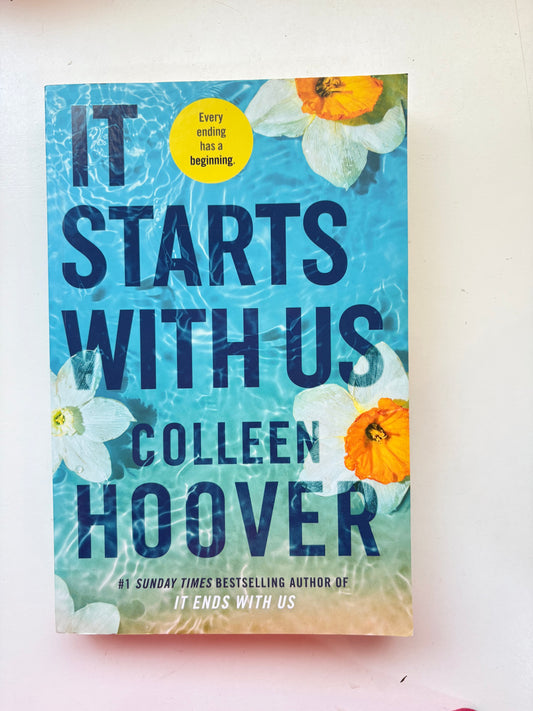 Book cover of 'It Starts With Us' by Colleen Hoover with floral elements on a light background