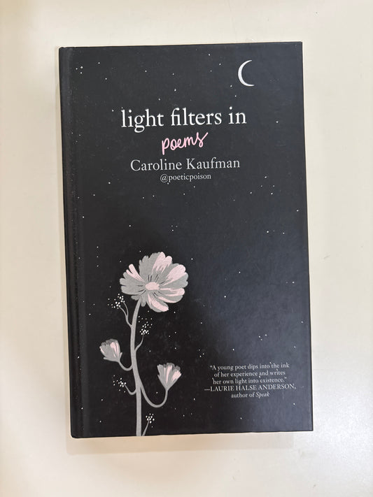 Book titled 'Light Filters in' with floral design on a white background