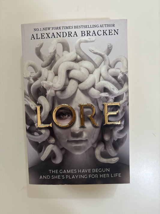 Book cover of 'Lore' by Alexandra Bracken with a woman's face and snakes on a white background