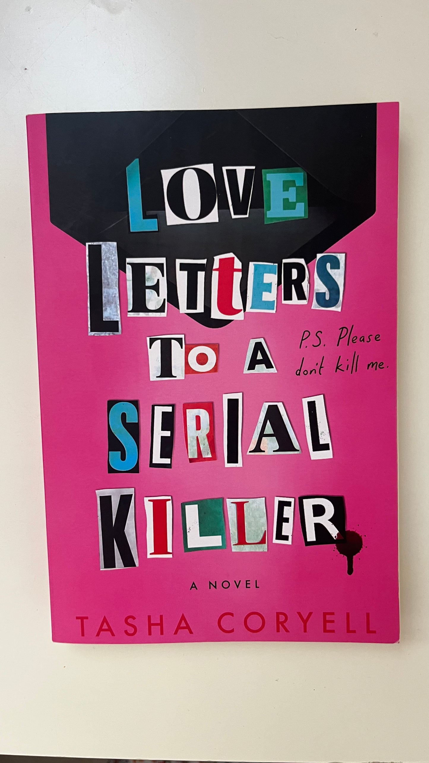 Paperback of Love Letters to a Serial Killer by Tasha Coryell with a moody, minimalist cover featuring typewritten letters.