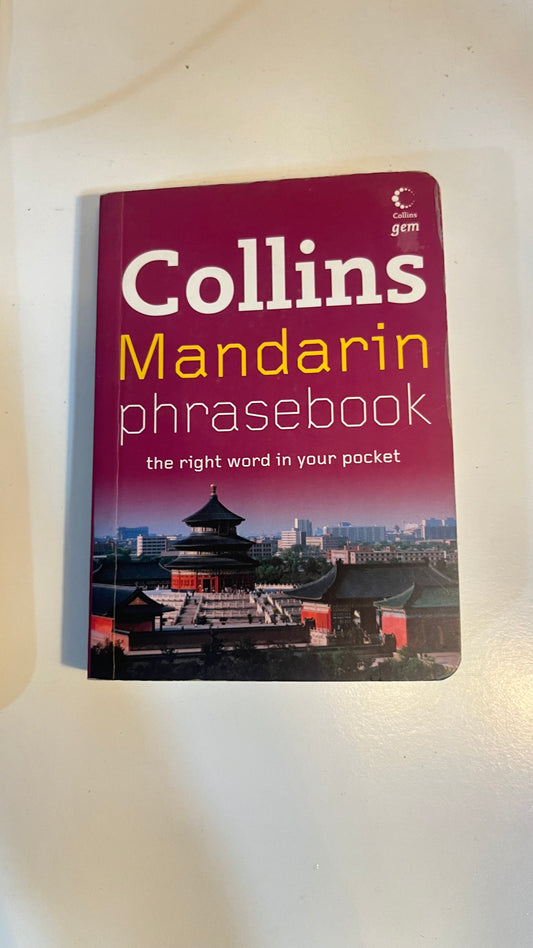 Cover of Collins Mandarin Phrasebook – essential travel language guide in red and white.