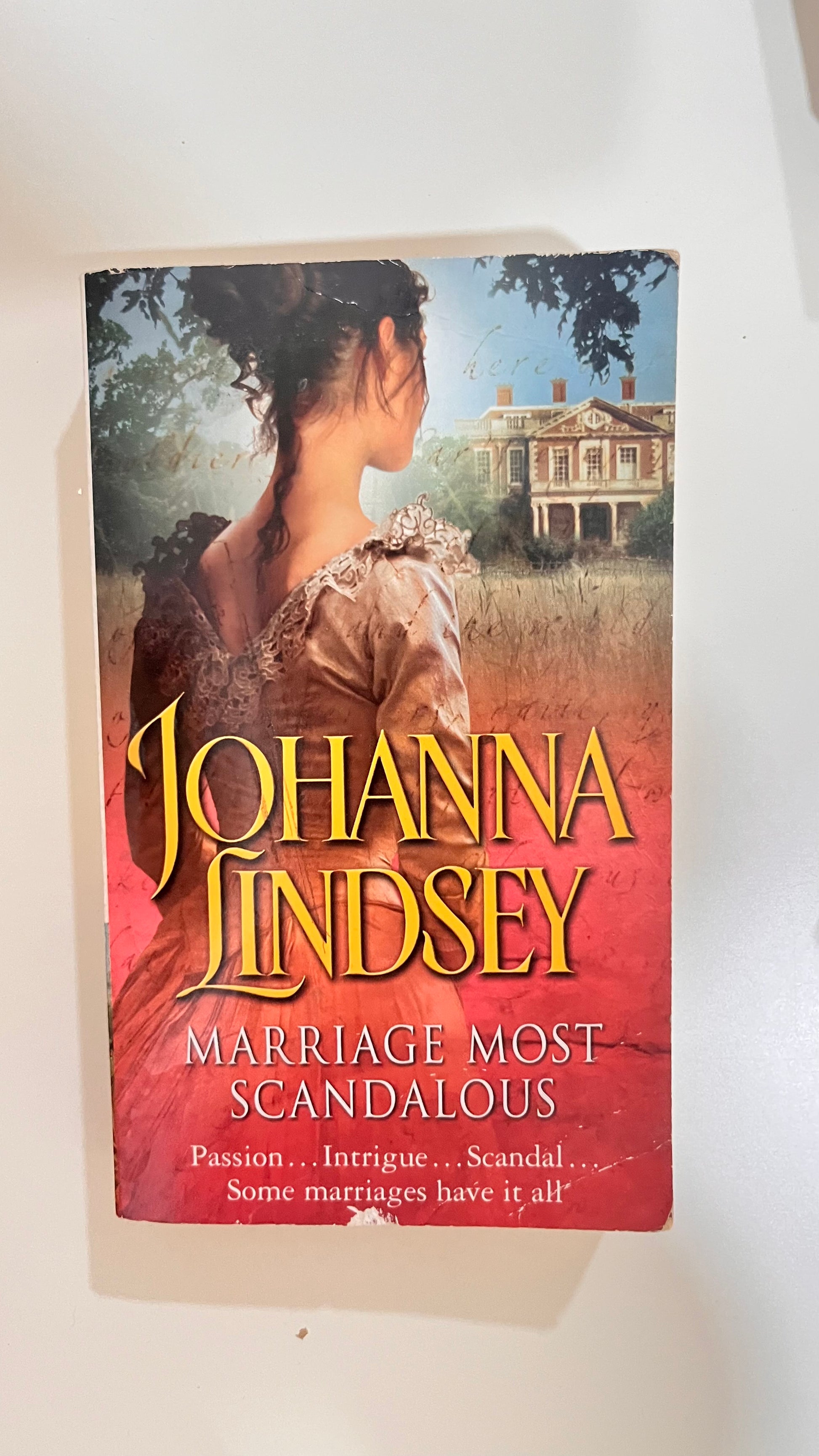 Vintage-style paperback of Marriage Most Scandalous by Johanna Lindsey with historical romance artwork.

