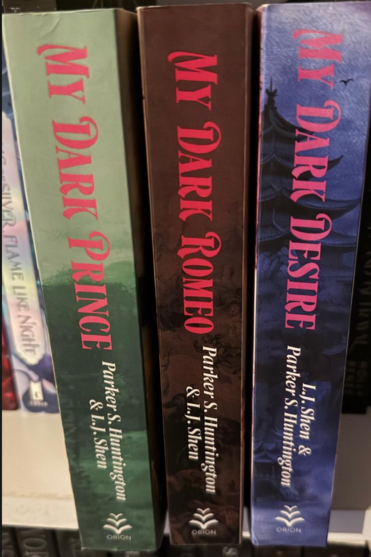 Three book spines titled 'My Dark Prince', 'My Dark Romeo', and 'My Dark Desire' by L.J. Shen and Parker S. Huntington.