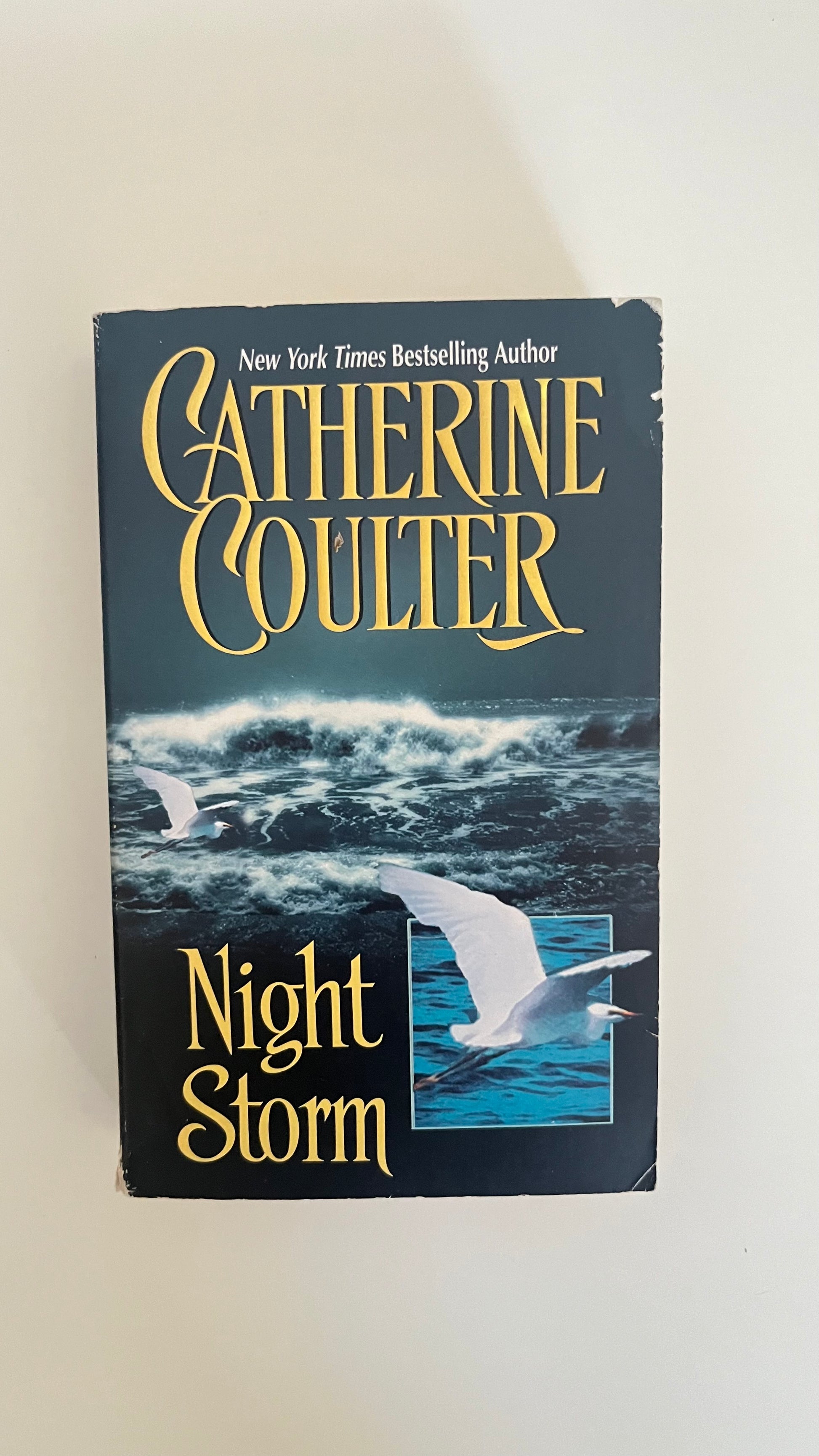 Paperback of Night Storm by Catherine Coulter with a dramatic cover of a ship sailing through rough seas.

