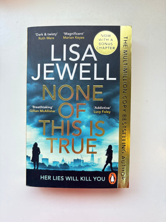 Book titled 'None of This is True' by Lisa Jewell on a white background