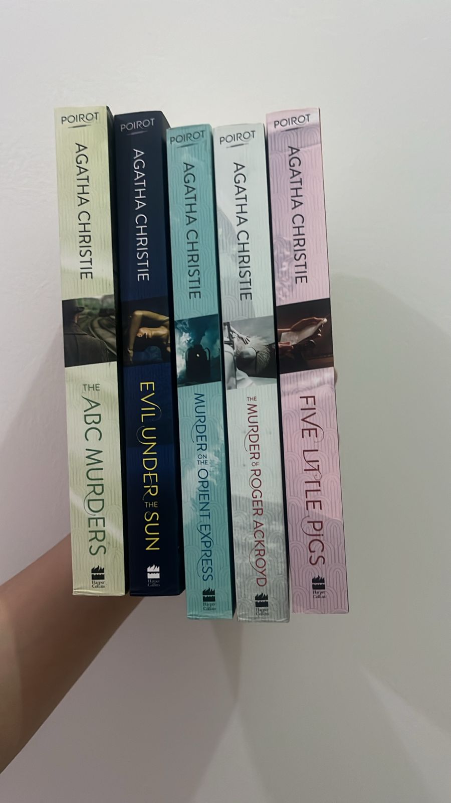 Set of Agatha Christie books arranged vertically on a white surface