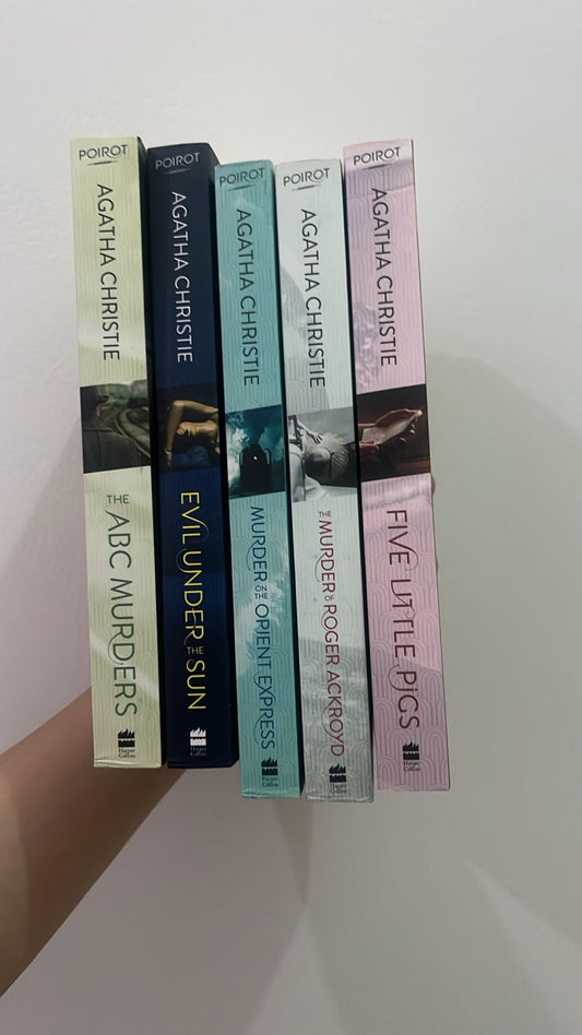 Set of Agatha Christie books arranged vertically on a white surface