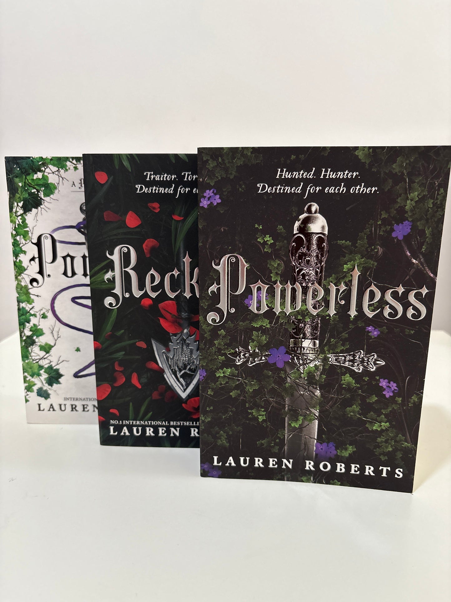 Book titled 'Black Promises' by Lauren Roberts on a white background