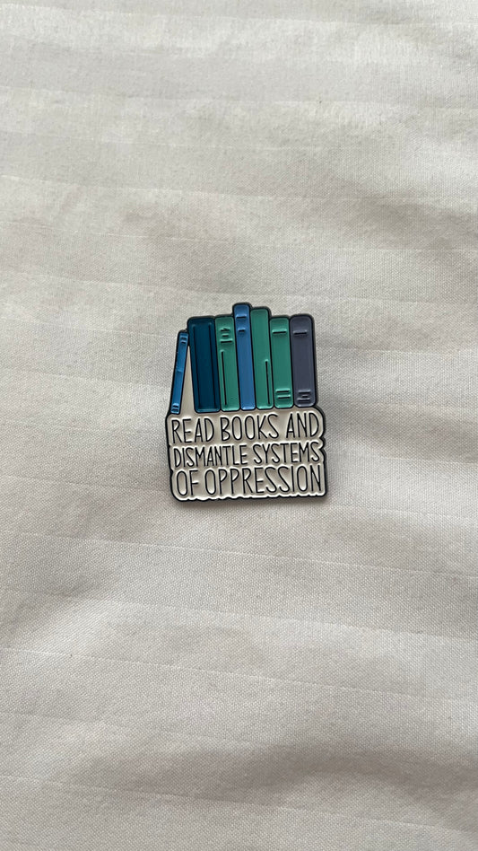 Enamel pin with quote: "Read books and dismantle the systems of oppression"

