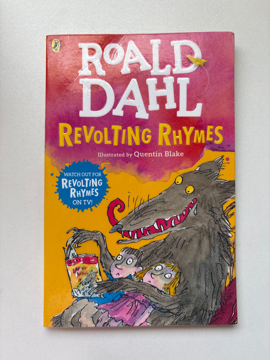 A hardcover children's book titled 'Roald Dahl's Revolting Rhymes' by Quentin Blake, featuring a colorful cover illustration of a wolf attacking a child, photographed on a light neutral background.